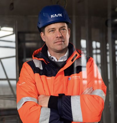 Algemeen directeur Robert van Boldrik kijkt vanaf een bouwproject naar buiten