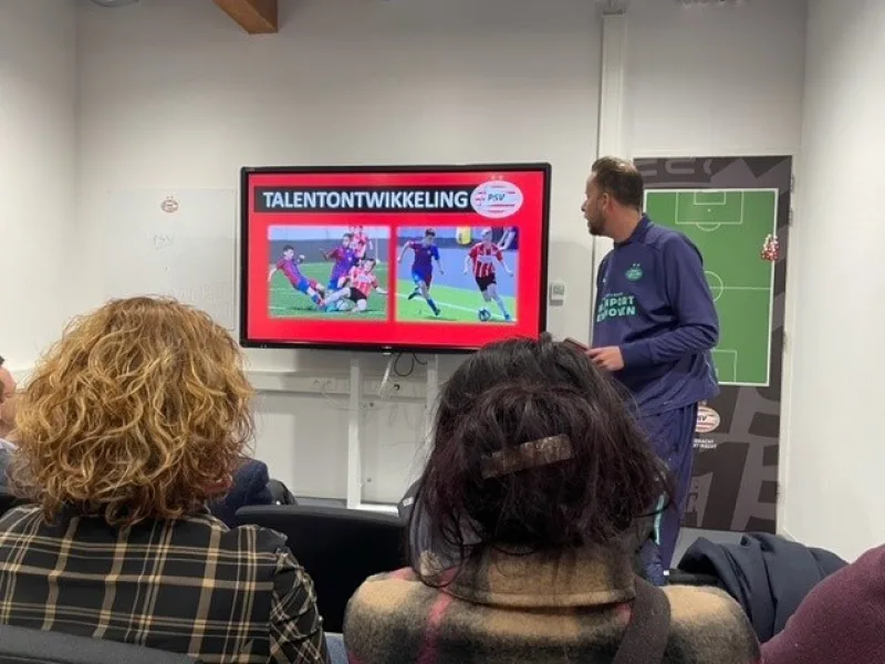 Presentatie over talentontwikkeling bij PSV met spreker en publiek
