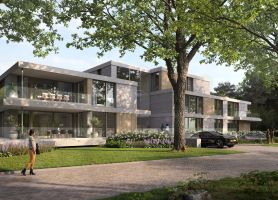 Appartementengebouw met grote balkons en glazen gevels tussen volwassen bomen en groenvoorziening