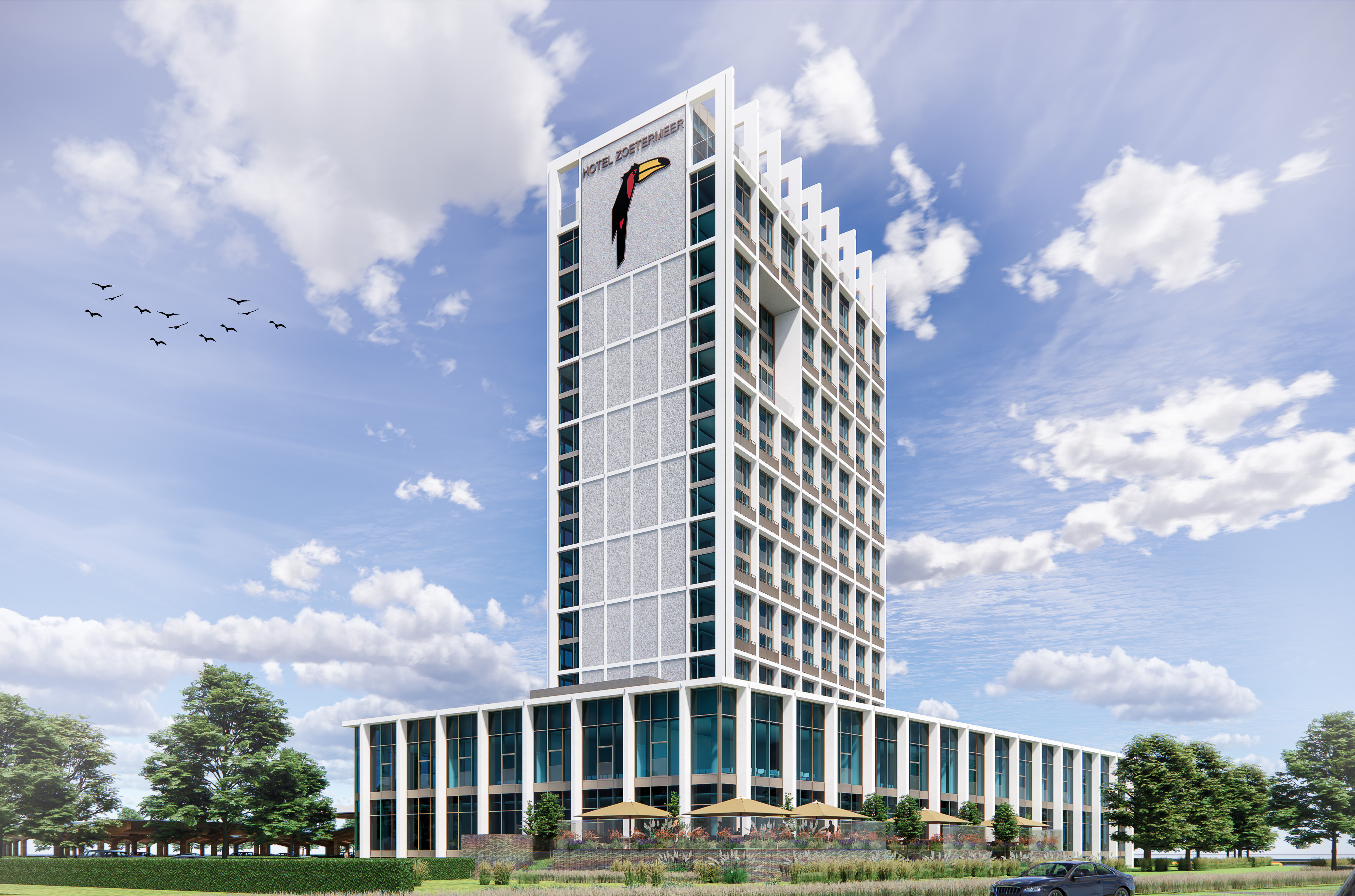 Overdagimpressie van het nieuwgebouwde Van der Valk Hotel Zoetermeer, met glazen gevel, parkeervoorziening en groene omgeving.