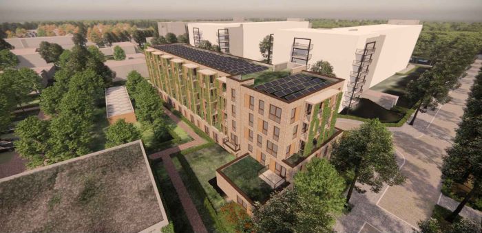 Luchtbeeld van het nieuwbouwproject aan de Hertoglaan in Vught met duurzaam ontworpen gebouw, groene gevels en parkachtige omgeving.
