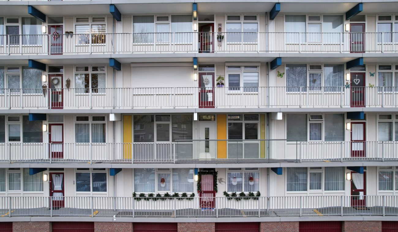 Appartementenflat met repetitie van balkons, galerijen en verlichting in de avondschemer — Groot onderhoud Albert Schweitzer Brunssum