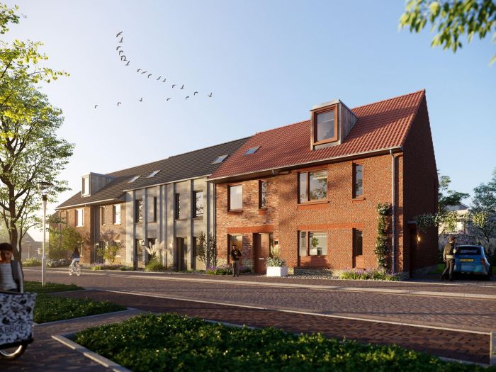 Nieuw Absbroek Geleen – rij nieuwbouwwoningen in rode baksteen en lichtgrijze gevel, zadeldaken met dakkapel en zonnepanelen aan groene woonstraat