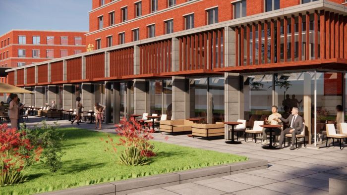 Impressie Van der Valk Maastricht-Maas: terras met houten lamellen en glazen gevel