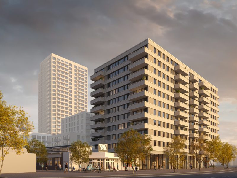 Close-up impressie van de nieuwbouwtoren bij het TAC-terrein in Eindhoven, met moderne gevels, balkons en een warme avondlichtinval.
